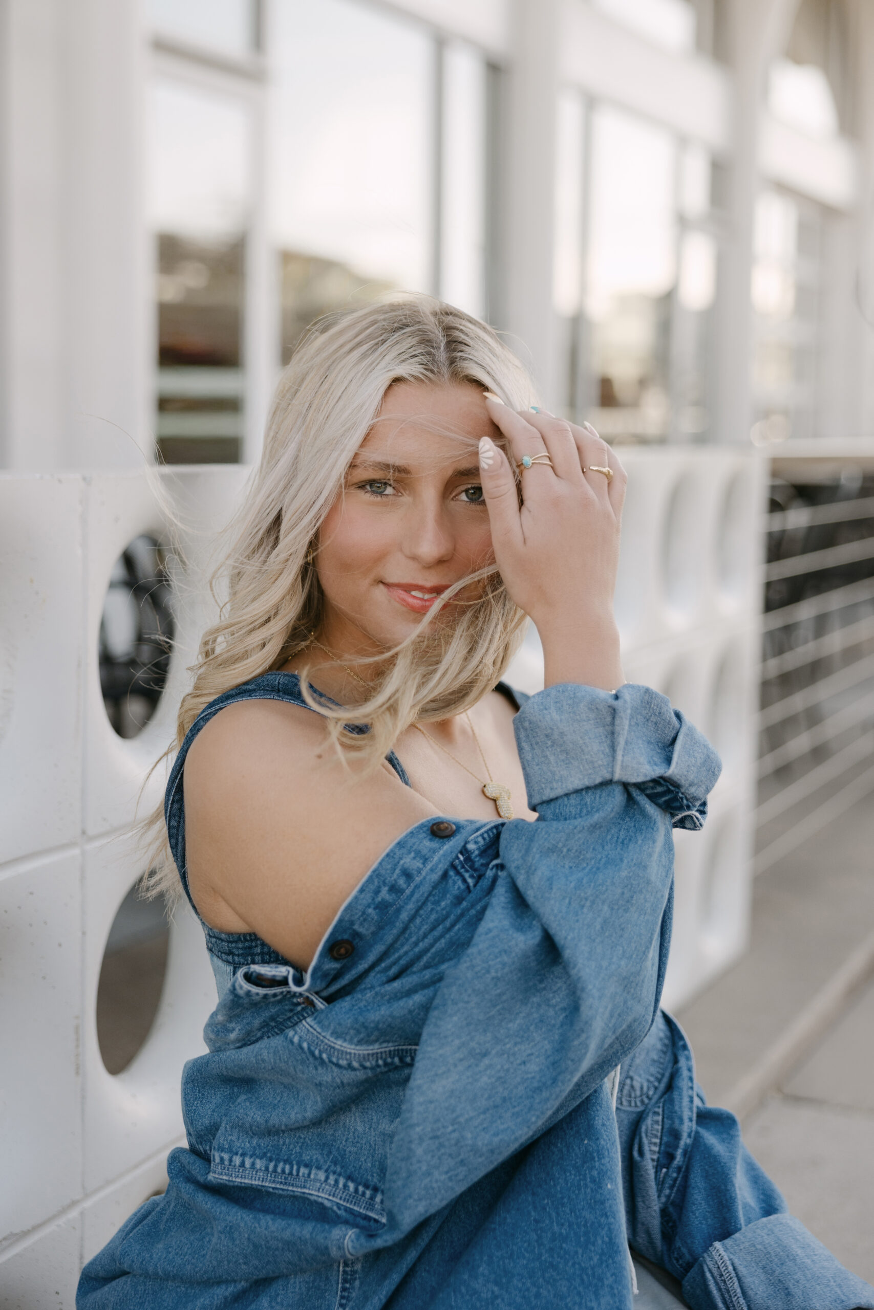 Northwest High School senior Tomi in a denim outfit posing during her Wichita senior photos at The Belmont in downtown Wichita Kansas